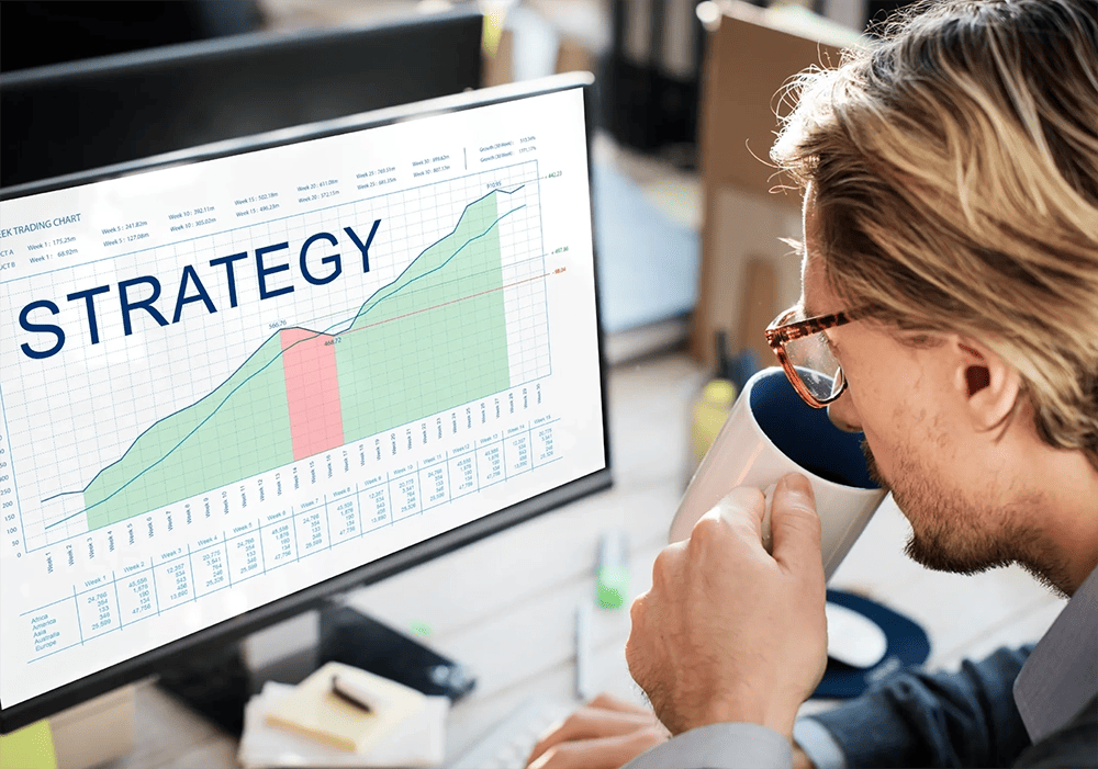 A man employing Account-Based Marketing (ABM) strategy, is focused on a computer screen.