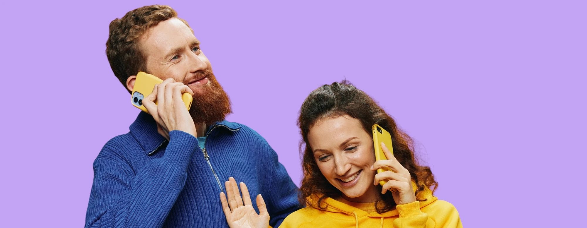 Two people talking on yellow smartphones. The person on the left is wearing a blue jacket; the person on the right is wearing a yellow sweater. The background is solid light purple.