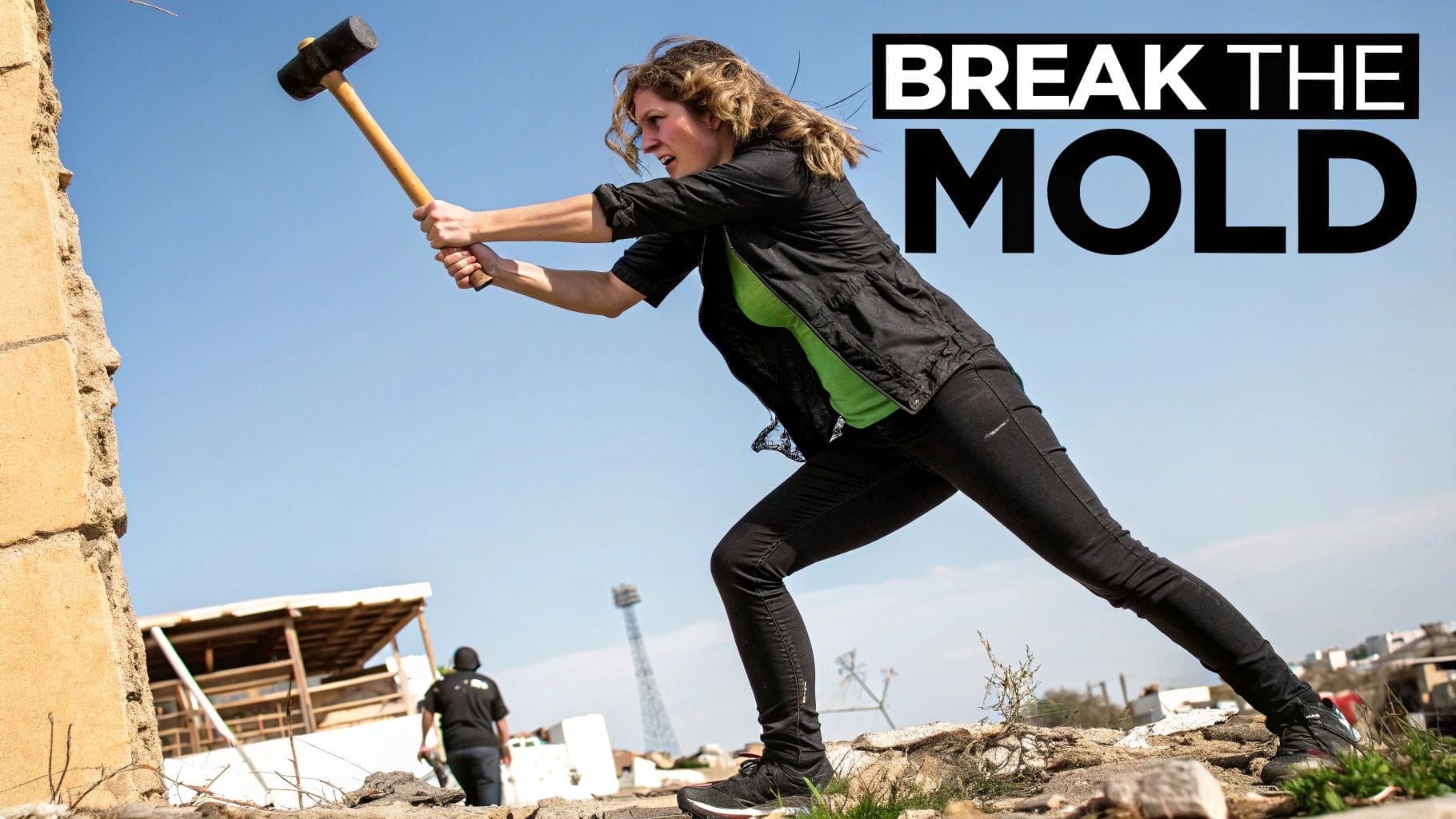 A woman swings a sledgehammer at a concrete wall outdoors, embodying an emotional advertising example, with the words "BREAK THE MOLD" in bold text beside her.