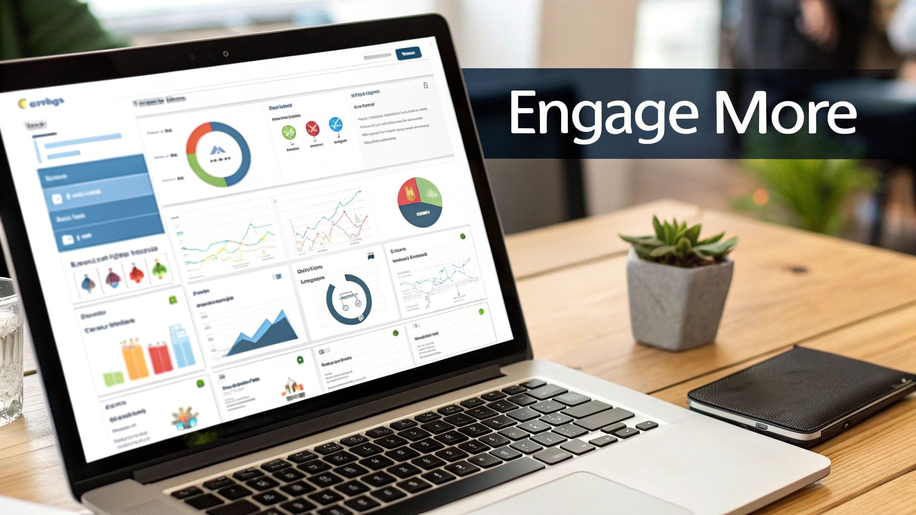 A laptop displaying various social media engagement metrics dashboards sits on a wooden desk next to a small potted plant and a phone, with the text "Engage More" on the screen.