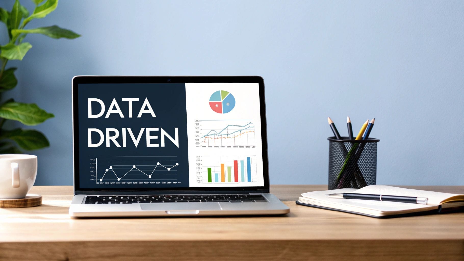 A laptop displaying the words "DATA DRIVEN" alongside charts and graphs sits on a desk with a notebook, cup, and pencils—perfect for planning strategies like how to monetize Instagram.